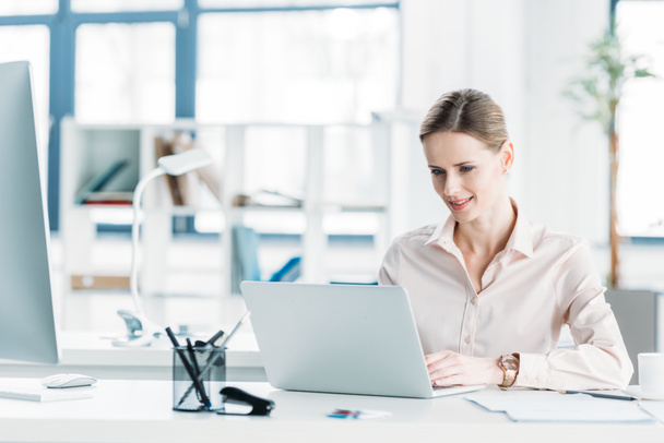 Bizneswoman pracuje na laptopie w biurze - Zdjęcie, obraz