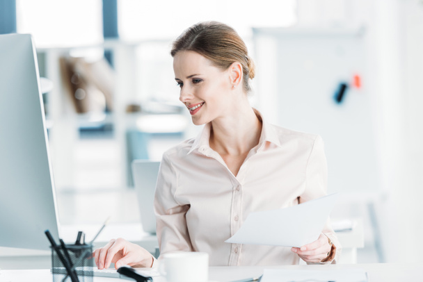 businesswoman working with documents and computer at office - Photo, Image