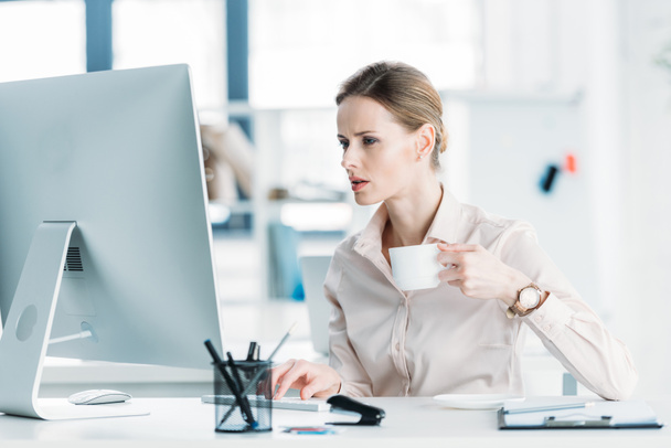 businesswoman working on computer and drinking coffee - Photo, Image