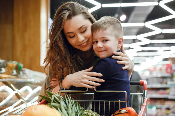 Woman with child in supermarket - Valokuva, kuva