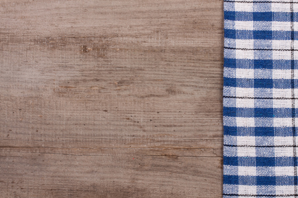 blue checkered tablecloth on an old wooden table with copy space for your text. Top view - Photo, Image