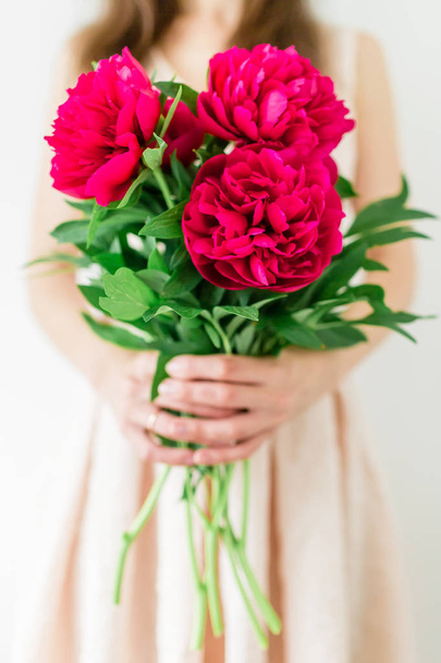woman holding in hands peony bouquet. - Photo, Image