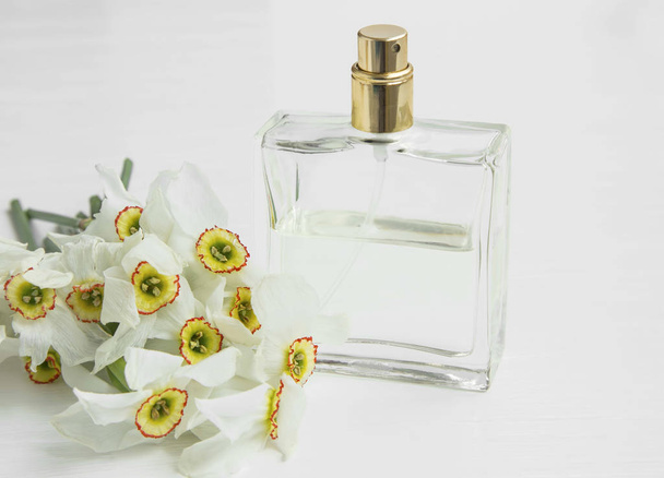 Daffodils perfume bottle and flowers - Photo, Image