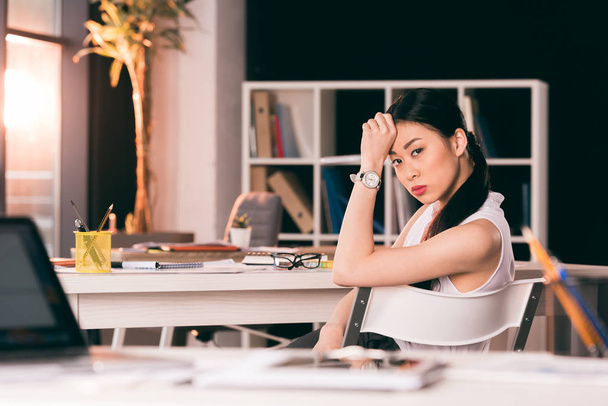 pensativo asiático mujer de negocios sentado en mesa
 - Foto, Imagen