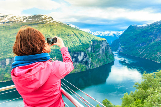 Tourist taking photo from Flydasjuvet viewpoint Norway - Фото, зображення