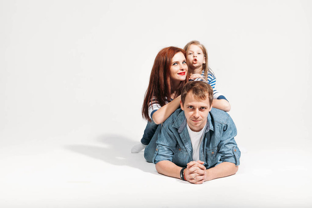Happy funny family portrait lying on white background isolated - Zdjęcie, obraz