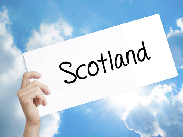Scotland Sign on white paper. Man Hand Holding Paper with text.  - Photo, Image