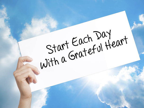 Start Each Day With a Grateful Heart Sign on white paper. Man Ha - Photo, Image