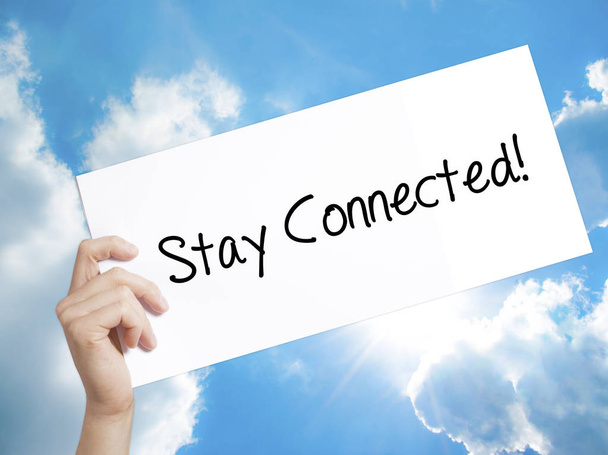 Stay Connected! Sign on white paper. Man Hand Holding Paper with - Photo, Image