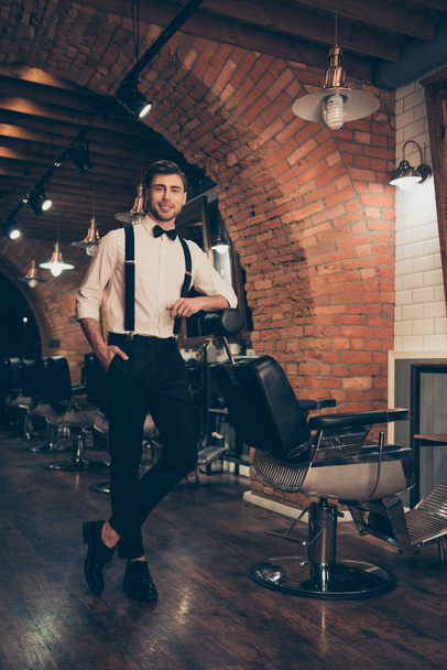 Handsome classy dressed stylist in a barber shop. He is successf - Foto, imagen