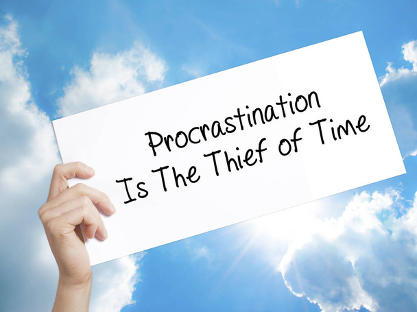  Procrastination Is The Thief of Time Sign on white paper. Man H - Photo, Image
