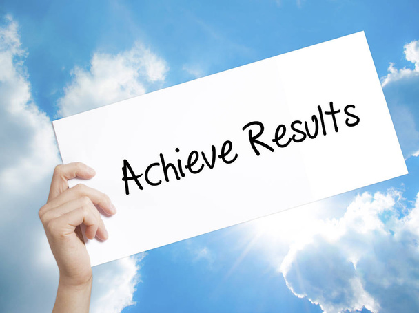  Achieve Results Sign on white paper. Man Hand Holding Paper wit - Photo, image