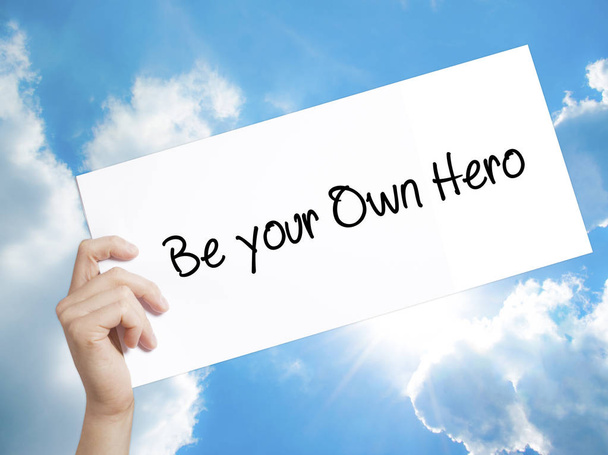  Be your Own Hero  Sign on white paper. Man Hand Holding Paper w - Photo, Image