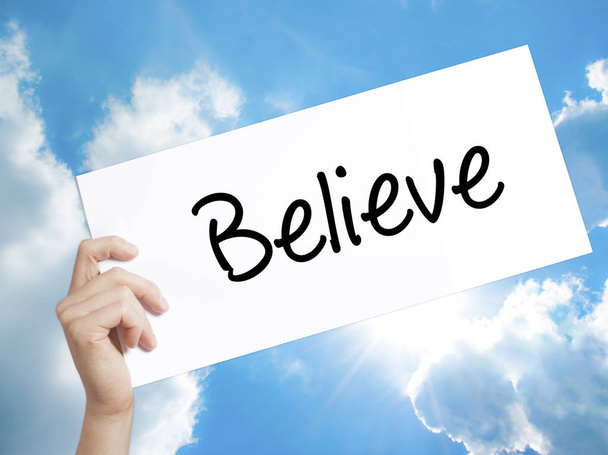 Believe Sign on white paper. Man Hand Holding Paper with text. I - Foto, Imagem