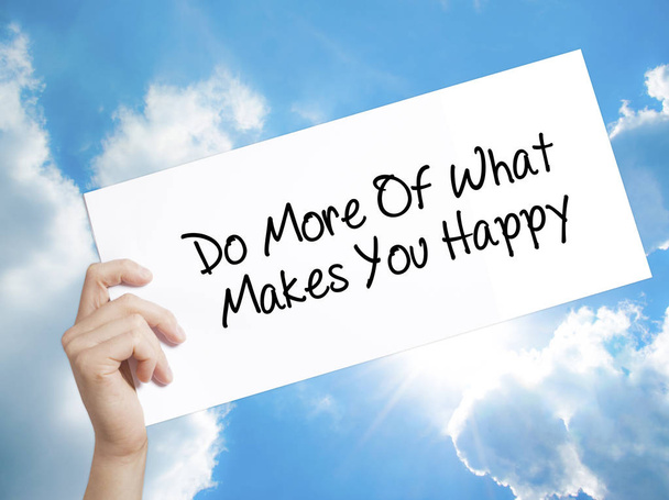 Do More Of What Makes You Happy Sign on white paper. Man Hand Ho - Photo, Image
