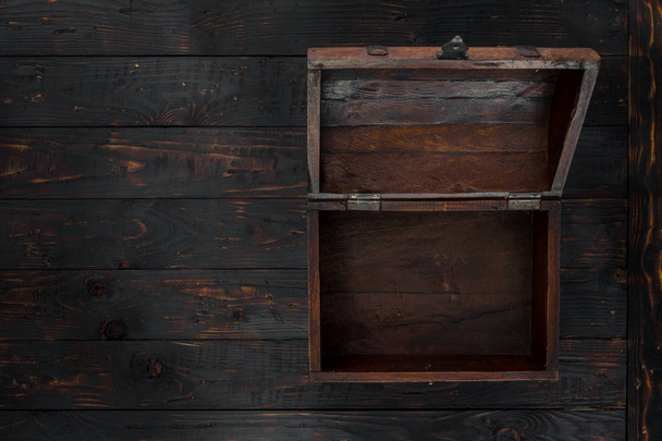 Old open chest close up on dark wooden table - Fotografie, Obrázek