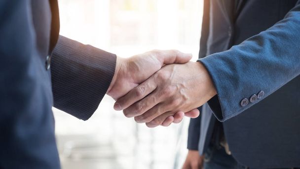 Two confident business man shaking hands during a meeting in the - Photo, Image
