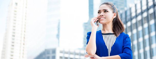 Young Asian businesswoman calling on smartphone - Photo, Image