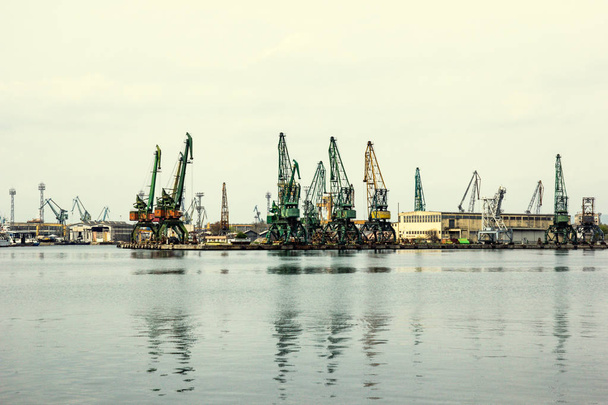 Grúas de puerto de carga en una costa de la ciudad
 - Foto, Imagen