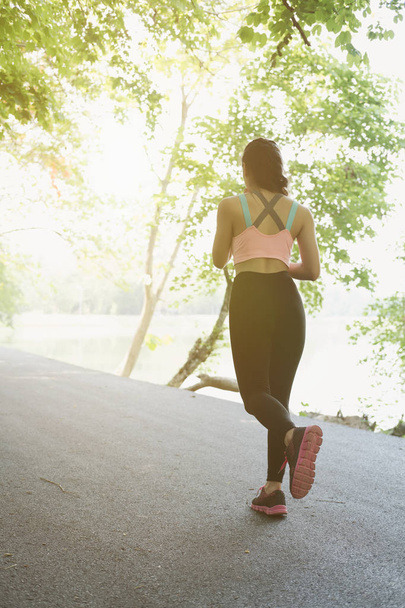 Female sport fitness runner jogging outdoors in spring or summer - Zdjęcie, obraz