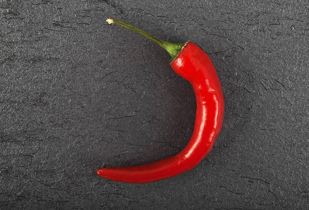 Red chili pepper on black background, top view - Foto, Bild