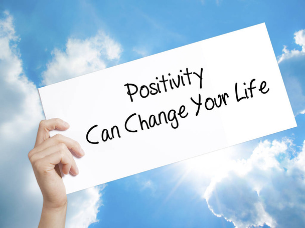 Positivity Can Change Your Life Sign on white paper. Man Hand Ho - Photo, Image