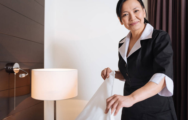 Happy delighted woman working as a hotel maid - Fotoğraf, Görsel
