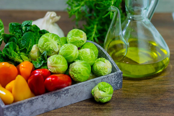 varied vegetables pepper, CABBAGE, onions and olive oil on a wooden background - 写真・画像