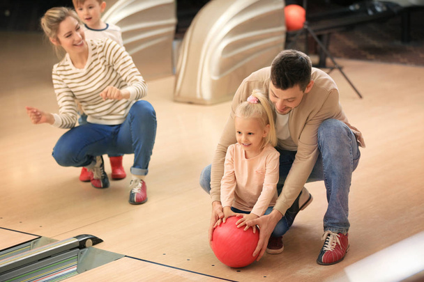 Family having fun at bowling club - Fotó, kép