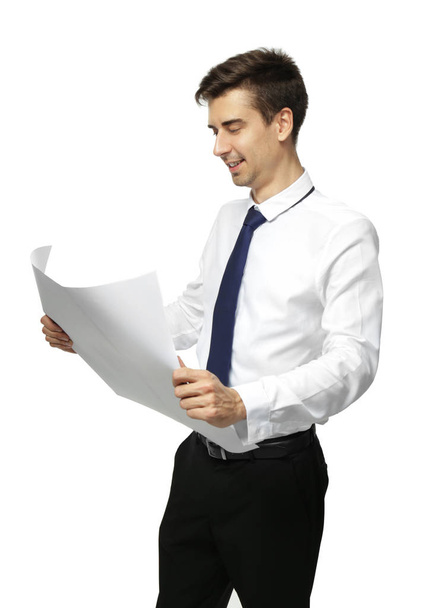 Young engineer holding blueprint on white background - Foto, afbeelding