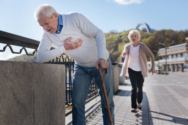 Aged pensioner having pain in his chest on the promenade - Foto, immagini