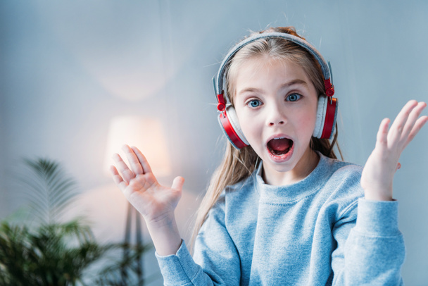 little girl in headphones - Фото, изображение