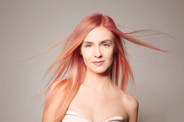 Young woman with strawberry blonde hair on color background - Fotografie, Obrázek