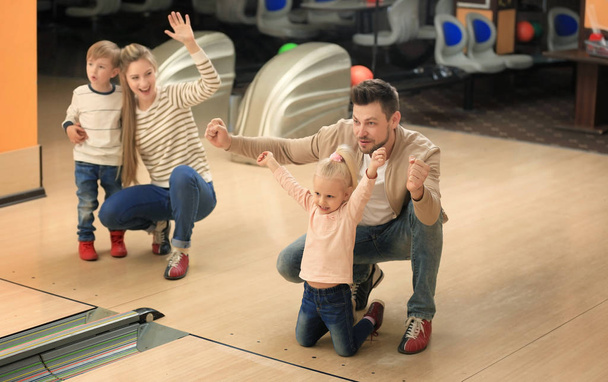 Family having fun at bowling club - Photo, image