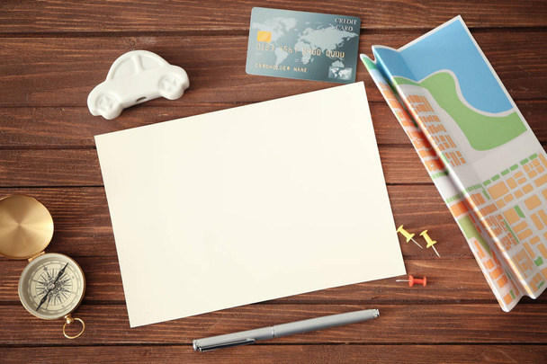 Blank notepad page, credit card and travel accessories on wooden background - Foto, Imagem