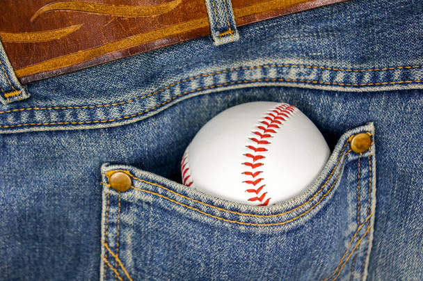 A baseball ball in a pocket of old legendary jeans - Фото, зображення