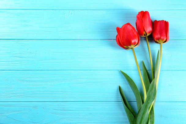 tulips on color wooden background - Photo, Image