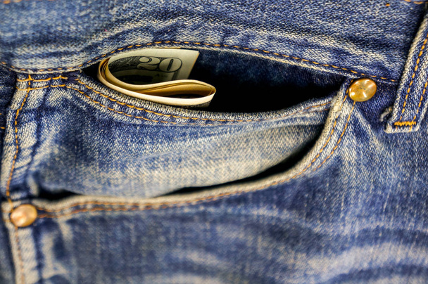 Money in a pocket of old jeans - Фото, зображення