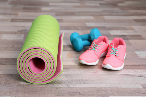 Yoga mat with sneakers and dumbbells   - Fotografie, Obrázek