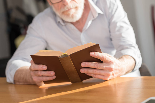 Mature man reading a book - Foto, Imagen