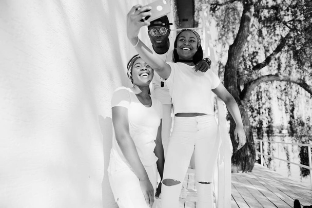 Three stylish african american friends, wear on white clothes ma - Foto, imagen