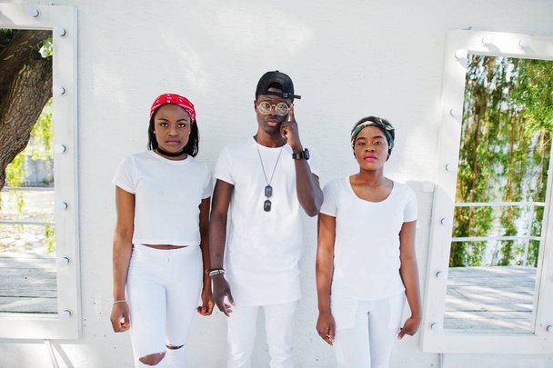 Three stylish and trendy african american friends, wear on white - Foto, imagen