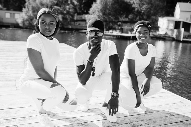 Three stylish african american friends, wear on white clothes at - Fotografie, Obrázek