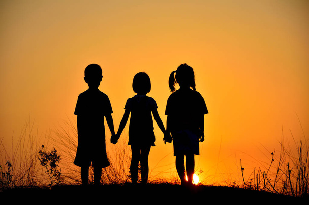  silhouette of three children - Φωτογραφία, εικόνα