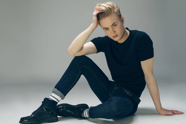 Young male model  sitting on teh floor looking at the camera   - Photo, Image