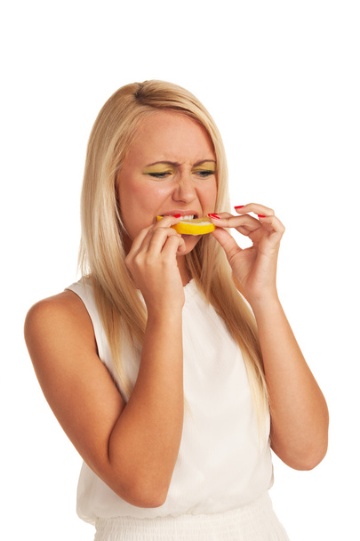 Girl eating lemon with displeasure - Foto, Imagem