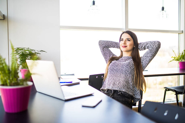 Portrait of young beautiful business woman relaxing at office. - Photo, Image