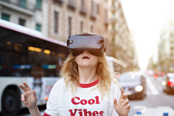 Blonde young woman uses VR headset - Foto, imagen