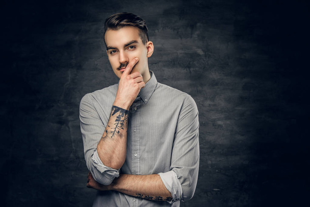 Thoughtful male with tattoo on his arm. - Photo, Image