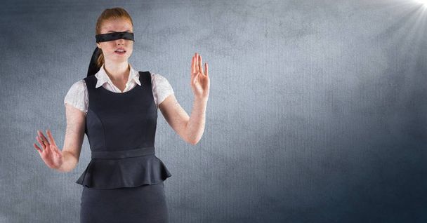 Business woman blindfolded against navy background with flare and grunge overlay - Valokuva, kuva